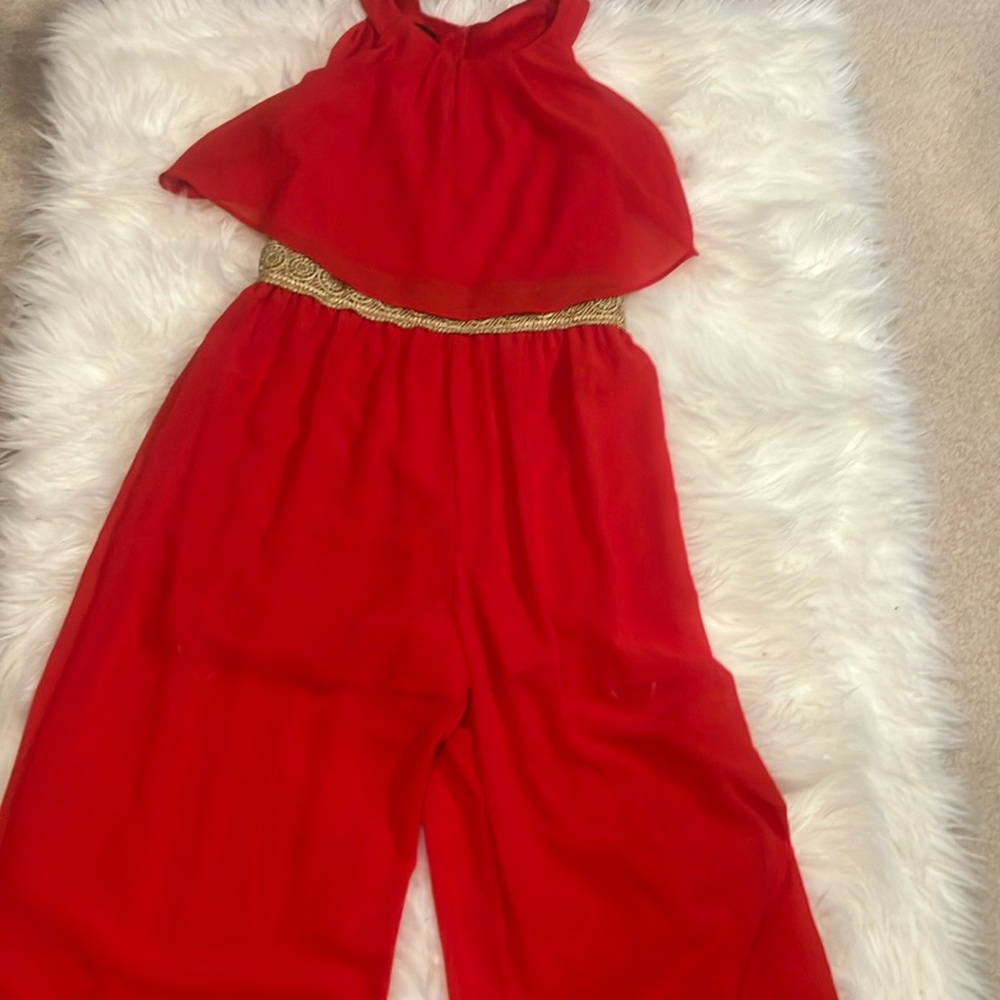 Red jumpsuit with a gold waist decoration